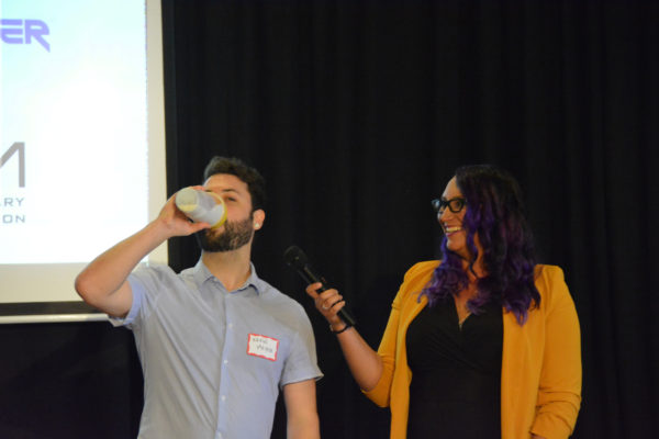 Crunch Cup co-founder Kevin Meyer demonstrates the use of portable "Crunch Cup" cereal cup onstage at Toolbox L.A. Grand Opening