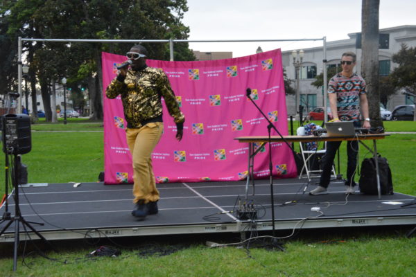 Rapper Payton 3.0 wears sparkly gold lame jacket as he performs onstage at SGV Pride 2018 in Central Park, Pasadena