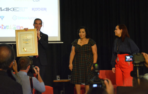 Mayor Eric Garcetti presents Noramay Cadena with a "Grand Opening" certificate at Toolbox L.A.