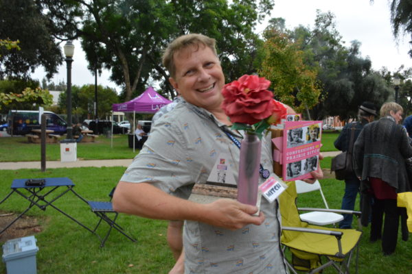 Mitch Braiman poses with his prizes after winning Alison Arngrim's award for her favorite car at SGV Pride 2018