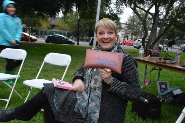 Alison Arngrim holds up "Nellies" zipper bag during SGV Pride 2018