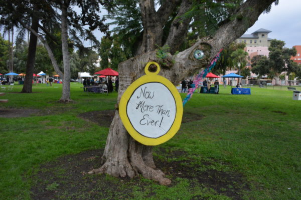 "Now more than ever" sign near San Gabriel Valley Pride exhibits