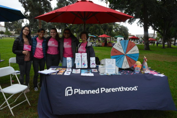 Planned Parenthood staff pose at their table at SGV Pride 2018