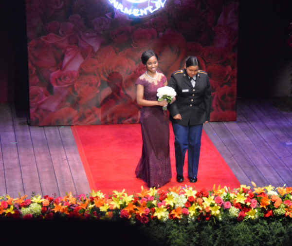 Rpse Princess Ashley Symone Hackett gets escorted onstage by a JROTC member in uniform