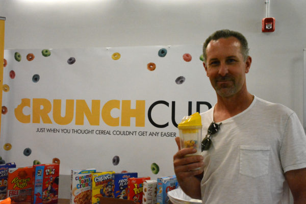 Crunch Cup co-founder Rob Lambert displays the world's first portable cereal cup at Toolbox L.A. Grand Opening