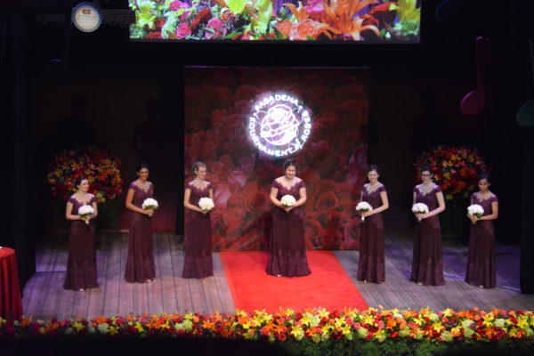 the seven members of the 2019 Royal Court stand onstage prior to the announcment of the Rose Queen