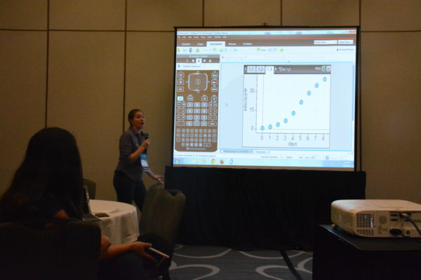 Randi Munch stands near a slide of a graph at California STEAM Symposium