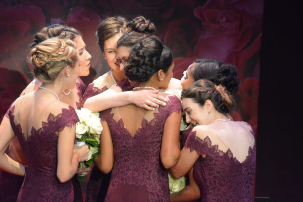 101st Rose Queen® Louise Siskel gets a hug from her Royal Court