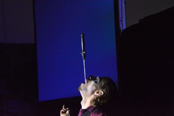 "Cydeshow Cy" swallows a sword against a blue-lit background at Scare L.A.