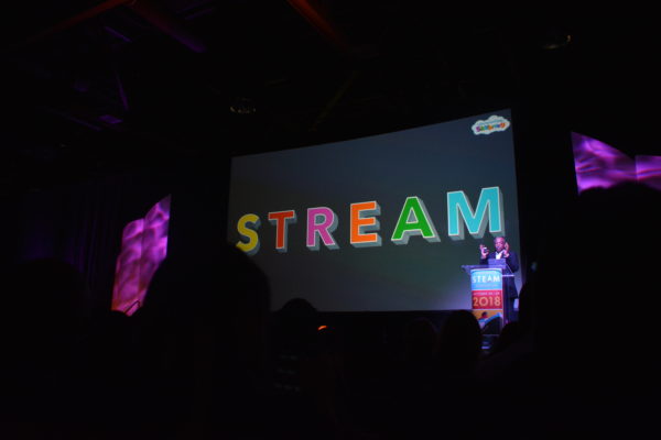 LeVar Burton at podium with slide that says STREAM in rainbow letters