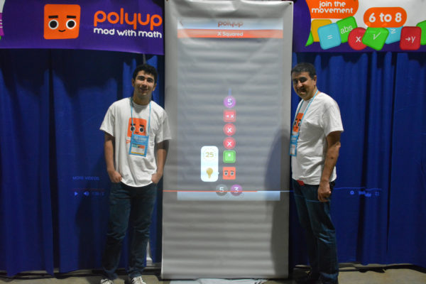 Shaya and Amir Zarkesh next to Polyup display at California STEAM Symposium