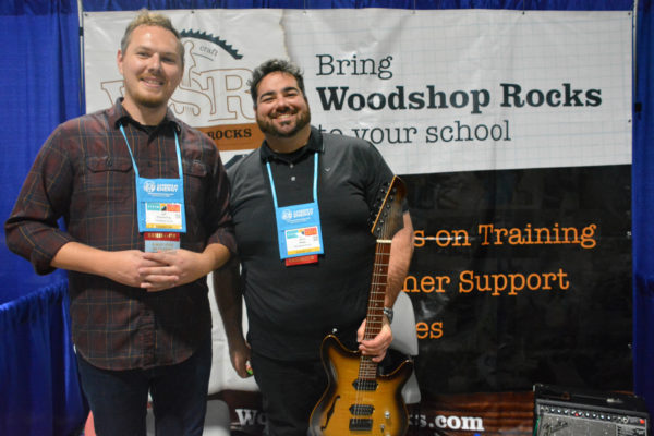 Exhibitors Jarred Haley and Jeff Emmerling smile at the Woodshop Rocks exhibit duiring Californai STEAM Symposium