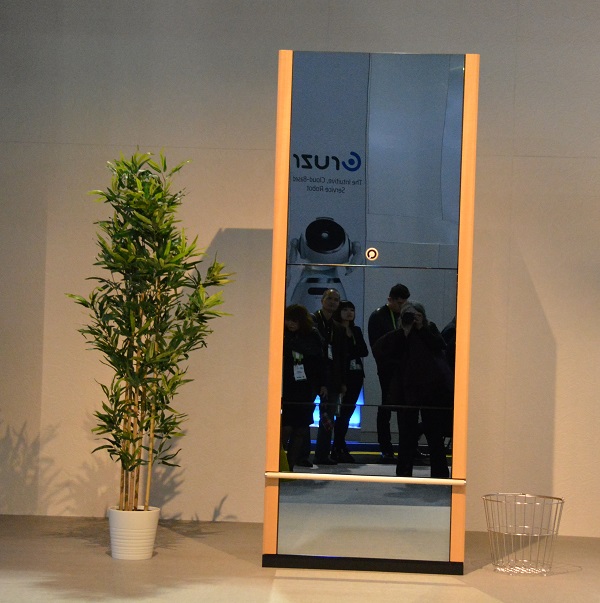 Laundroid robot which looks like a wardrobe with mirrors on its doors, standing on CES 2018 show floor