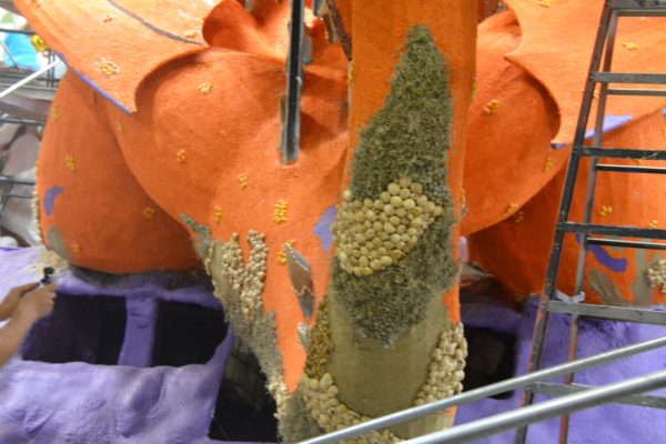 Closeup of mushrooms, orange lentil seed and Spanish moss on the tail of the "dragon" Rose Parade® float