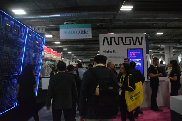 Eureka Park attendees walk towards Arrow sign on show floor