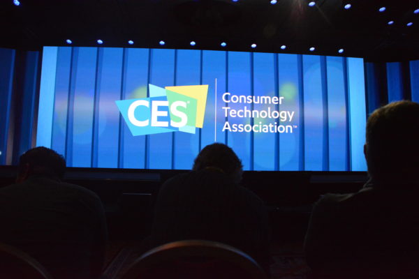 Audience members sit before CES screen prior to CES Day One keynotes