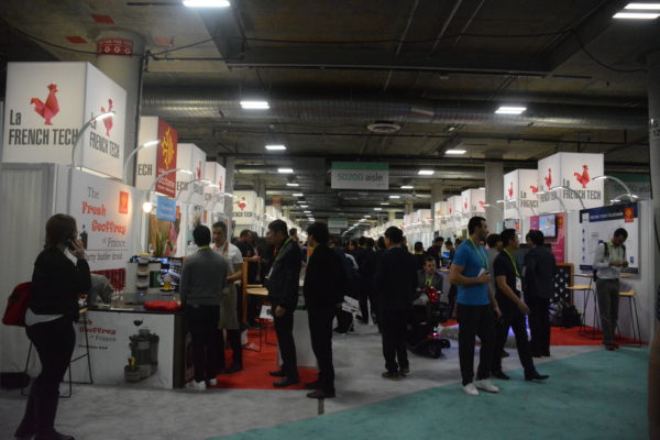 Attendees in the aisle of Eureka Park, with signs saying, "French startups" on either side