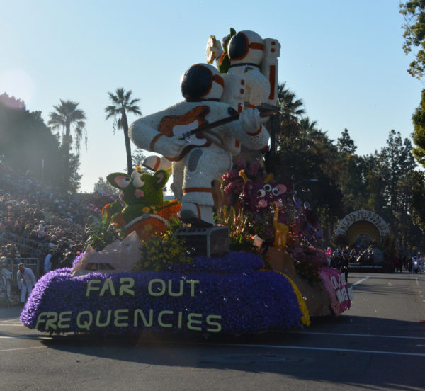 "Far Out Frequencies" float with two astronauts and green space aliens rolls on parade route