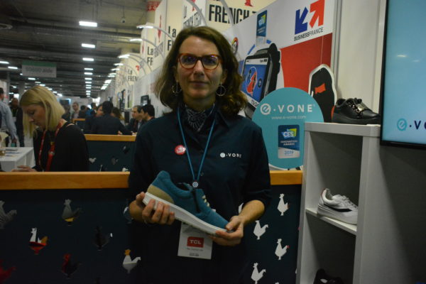 Lauren holds blue suede E-vone smart shoe at Eureka Park Marketplace