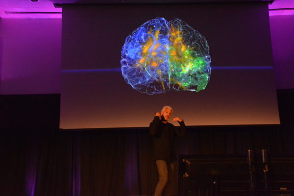 Dr. Gazzaley shows lside of brain lit up with numerous colors in its synapses