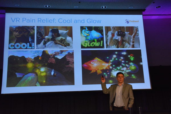 Howard Rose before slide displaying two of his company's medical VR games, "Cool" and "Glow"