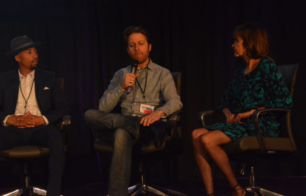 Mark speaks as Denise Silber and Harmon Clarke listen during Virtual Medicine conference 2019