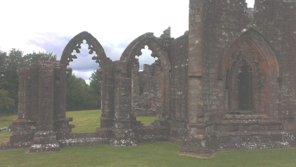 Misty ruins of Gothic church with arches