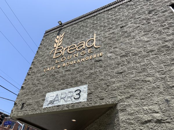Bread Lounge sign on building facade with wheat logo