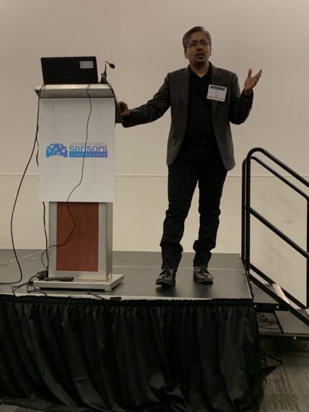 Dr. Amrit Sinha on the podium at Autonoous Vehicles Conference