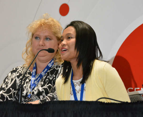 Jocelyn speaks into microphone as Marlena listens during Women in Sensors Engineering panel