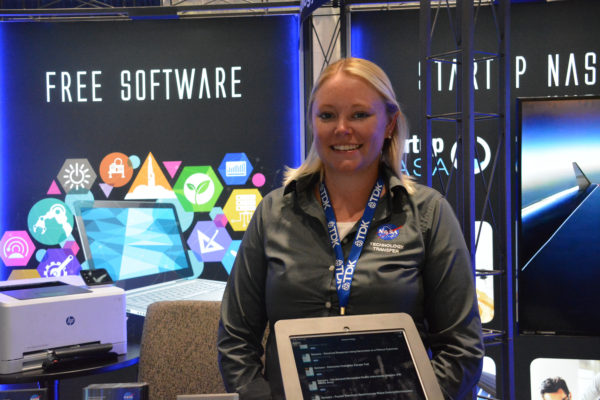 Exhibitor smiles from nASA satrtup exhibit at Sensors Expo