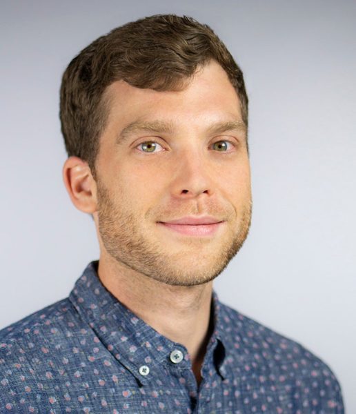 Headshot of IBM Watson AI XPRIZE Director and Global Learning XPRIZE DirectorDevin Krotman, wearing a navy button down shirt.