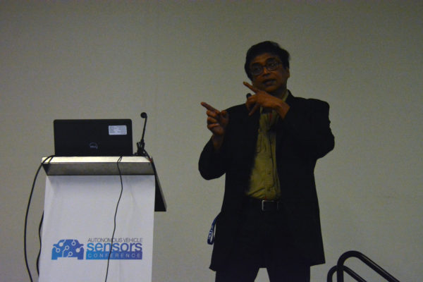 Manju gestures with two fingers during Autonomous Vehicle Sensors Conference