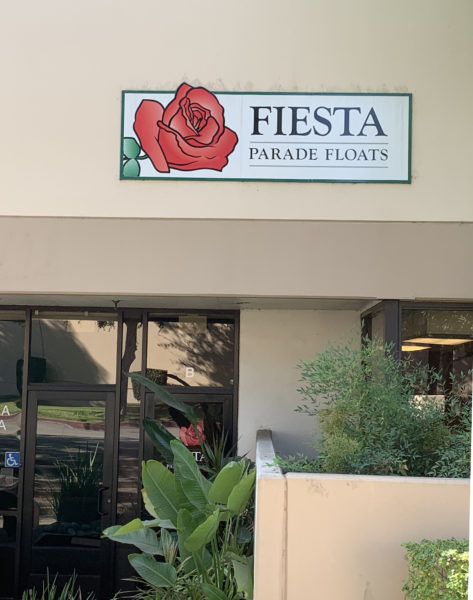 Fiesta Parade Floats sign with graphic of a red rose over the main office door