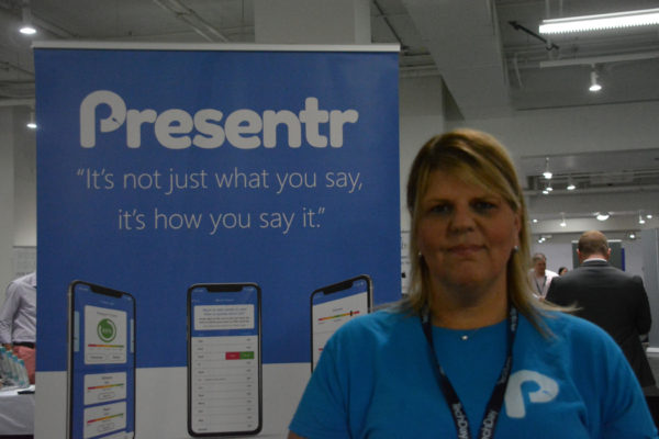 Presentr COO and Co-Founder Tammy Palazzo near a "Presentr" sign at her exhibit during TechDay L.A.