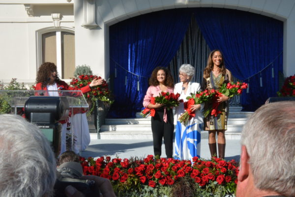 Tournament of Roses Prsident Laura Farber gestures toward three new Grand Marshals