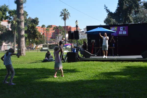 Young girls dance as rapper Figgy Baby performs onstage during San Gabriel Valley Pride 2019