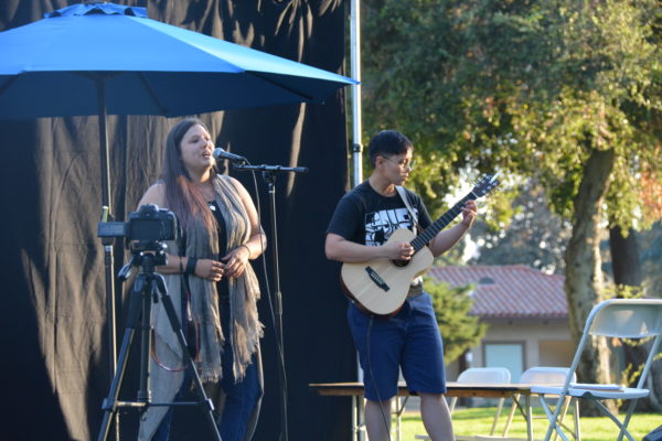 Niccole sings as Ace plays guitar at San Gabriel Valley Pride 2019