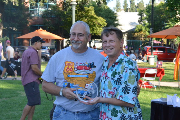 People's Choice winner stands with Mitch Braiman at San Gabriel Valley Pride car show