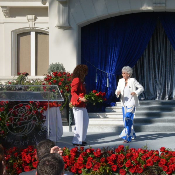 Grand Marshal Rita Moreno does a jazzy step towards Tournament of Roses President Laura Farber