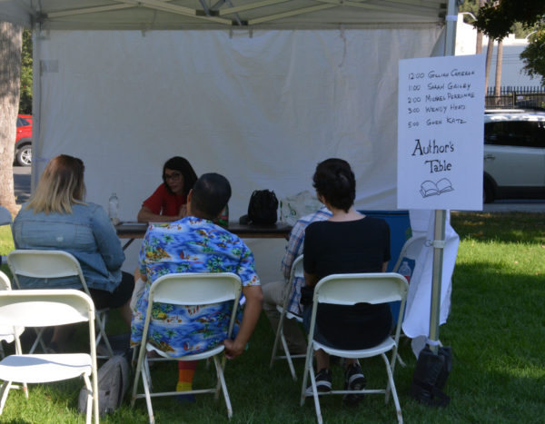 Author Wendy Heard talks with gathered SGV Pride attendees at the Authors Table
