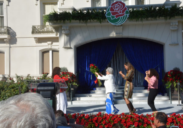Grand Marshal Rita Moreno leads line wiht rose bouquet