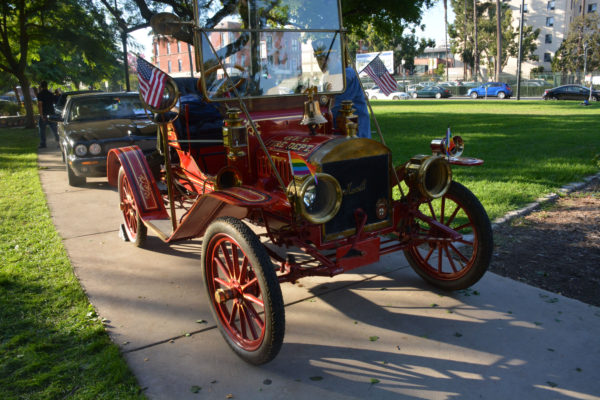 1911 fire engine sits proudly at front of line of classic cars parked on asphalt in Central Park for SGV Pride Auto Show