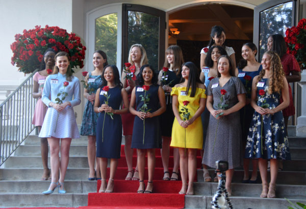 Rose Court finalists stand on red-carpeted stairs of Tournament House