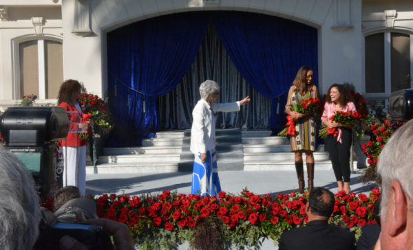 Grand Marshal Rita Moreno raises hand to indicate Laurie Hernandez