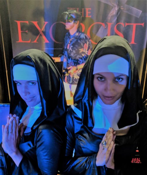 Two women in nuns' habits fold hands before banner with "The Exorcist: Legion VR"