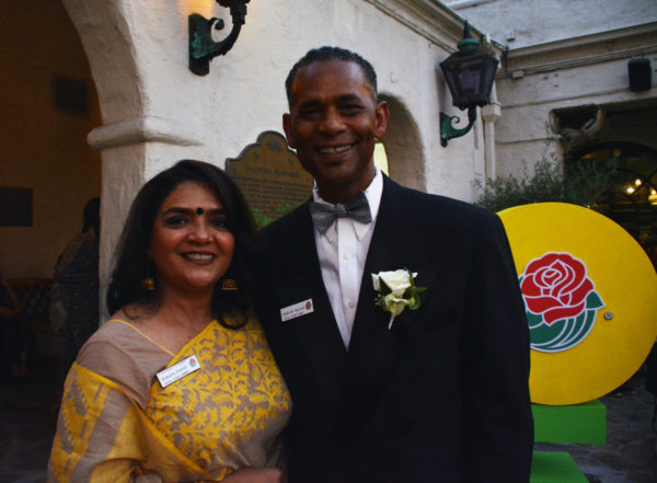 Father and mother of two different Royal Court members smile as they pose for a picture on the Pasadena Playhouse patio