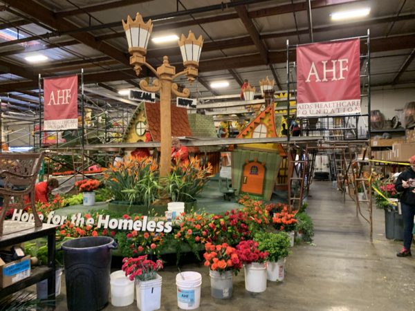 Houses on the AHF float, behind buckets of red roses waiting to be put on the float