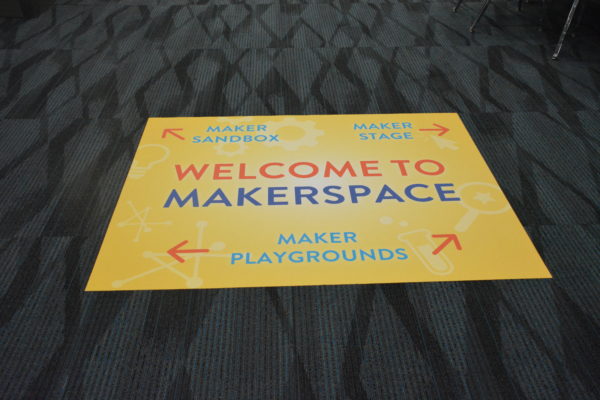 Floor mat says "Welcome to Makerspace" with three areas indicated: Maker Playgrounds, Maker Sandbox and Maker Stage