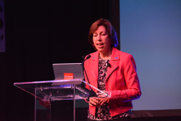 Medium shot of Dr. Ellen Ochoa as she speaks from the lectern of California STEAM Symposium 2019